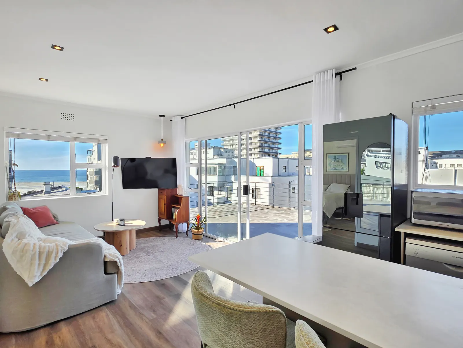 14 Plomarion - bright open-plan living room opening onto a large balcony